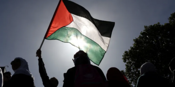 A person holds a Palestinian flag during the annual Quds Day (Jerusalem Day) in Cape Town, South Africa on April 14, 2023