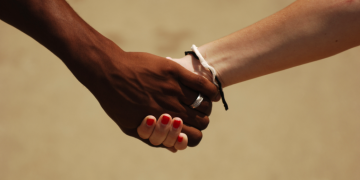 Pregnant man and multi-racial handshake among gender-neutral